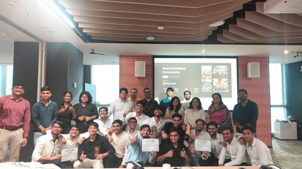 Team photo with trophies and certificates at an Azure Developer Community event